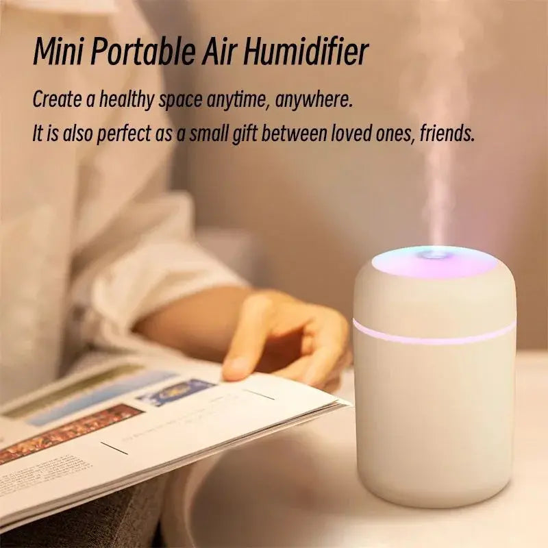 Mini Portable Air Humidifier in home on table releasing mist