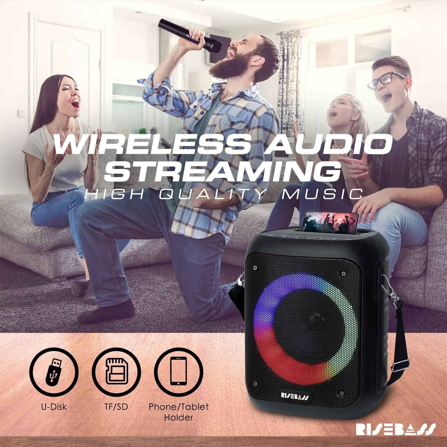 karaoke machine with LED lights and 2 wireless microphones. phone on top of karaoke machine.  Man singing in front of people in living room.